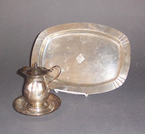 AMERICAN SILVER SMALL TRAY & SYRUP JUG T: AMERICAN SILVER SMALL TRAY & SYRUP JUG The tray, International, rounded rectangular with shaped corners, initialled in center; the syrup jug of baluster form with a domed lid and circular under tray.