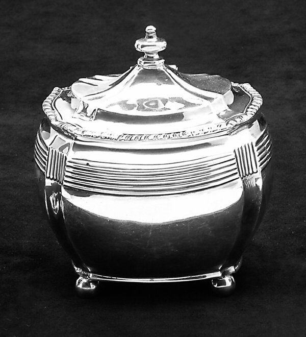 ENGLISH SILVER TEA CADDY Charles Stuart: ENGLISH SILVER TEA CADDY Charles Stuart Harris, London 1903 Oblong with concave corners, the reeded neck below a hinged domed conforming lid and gadrooned rim, on four ball feet. Uninitialled. Light d