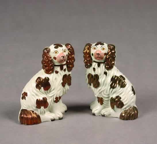 A Pair of Staffordshire Pottery Copper L: A Pair of Staffordshire Pottery Copper Lustre Dogs. Height 7 1/4 inches each.Provenance:Estate of William R. Brown