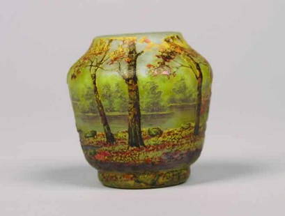 A Daum Etched and Enameled Miniature Vas: A Daum Etched and Enameled Miniature Vase, decorated with a forested river landscape, signed "Daum Nancy" with the Croix de Lorraine.Height 2 1/4 inches.