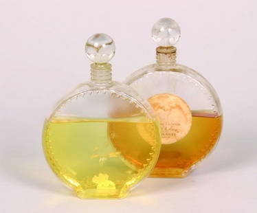 Two Lalique Perfume Bottles for Nina Ric: Two Lalique Perfume Bottles for Nina Ricci, the necks molded "NR", molded "Lalique, France" on the base.Height 6 5/8 inches.Provenance:Estate of Lillian Questiaux