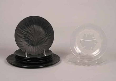 Seven Lalique Black Glass Plates,: Seven Lalique Black Glass Plates, in the See Grass pattern, comprising six lunch plates and one dinner plate, signed Lalique France, together with a clear and frosted glass plate, signed Lalique