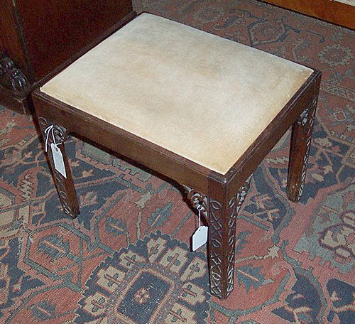 GEORGE III-STYLE MAHOGANY STOOL 19th c. I: GEORGE III-STYLE MAHOGANY STOOL 19th c. In the manner of Thomas Chippendale, the drop-in seat raised on four blind fret- carved chamfered square legs with pierced angle brackets.