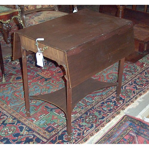 GEORGE III MAHOGANY PEMBROKE TABLE Ca. 1: GEORGE III MAHOGANY PEMBROKE TABLE Ca. 1770 In the manner of Thomas Chippendale, the drop-leaf top over a frieze drawer, raised on square legs with pierced angle brackets, joined by a shaped undertier
