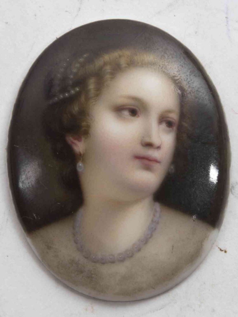 A German Porcelain Plaque, after Titian, Height 1 7/8: A German Porcelain Plaque, after Titian, of oval form, depicting Venus from Titian's "Venus and the Lute Player," the back stamped 20. Height 1 7/8 inches. Property from the Chicago Historical Society
