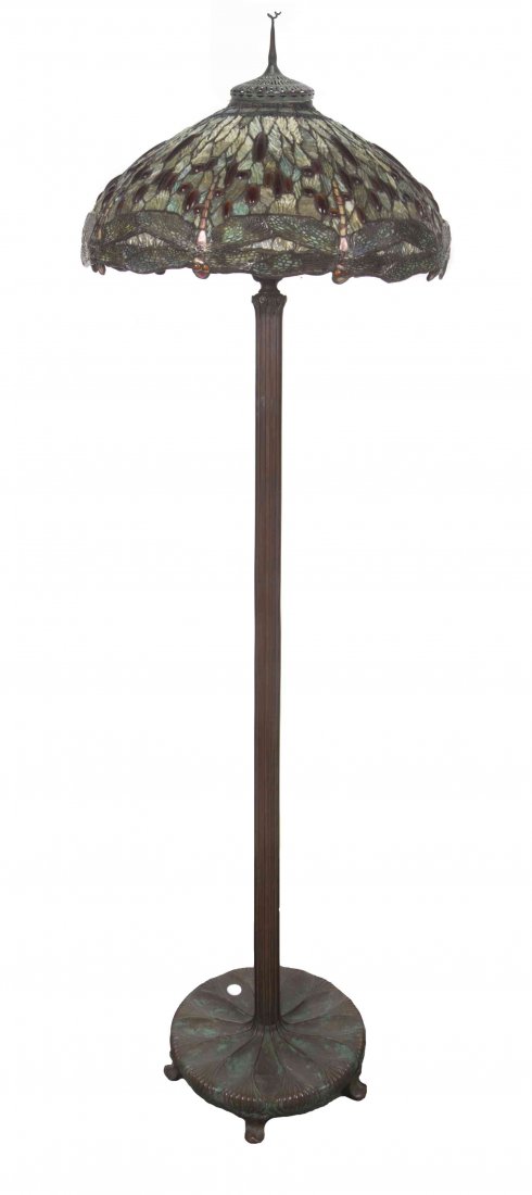An American Leaded Glass Drop Head Dragonfly Floor: An American Leaded Glass Drop Head Dragonfly Floor Lamp, the heat cap having a tear drop finial over the domed shade with mottled glass and bead decoration, with six lighting elements, raised on a ree