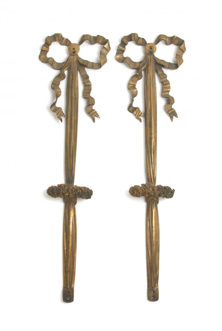 A Pair of Gilt Bronze Wall Appliques, Height 22 3/4: A Pair of Gilt Bronze Wall Appliques, each in the form of a tied ribbon. Height 22 3/4 inches. Property from the Estate of a Prominent Midwest Collector