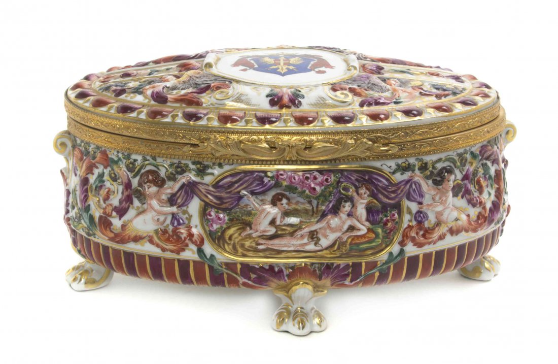 A Capodimonte Porcelain Table Casket, Width 9 inches.: A Capodimonte Porcelain Table Casket, of oval form with molded figures throughout, raised on paw feet. Width 9 inches. Property from the Estate of a Prominent Midwest Collector