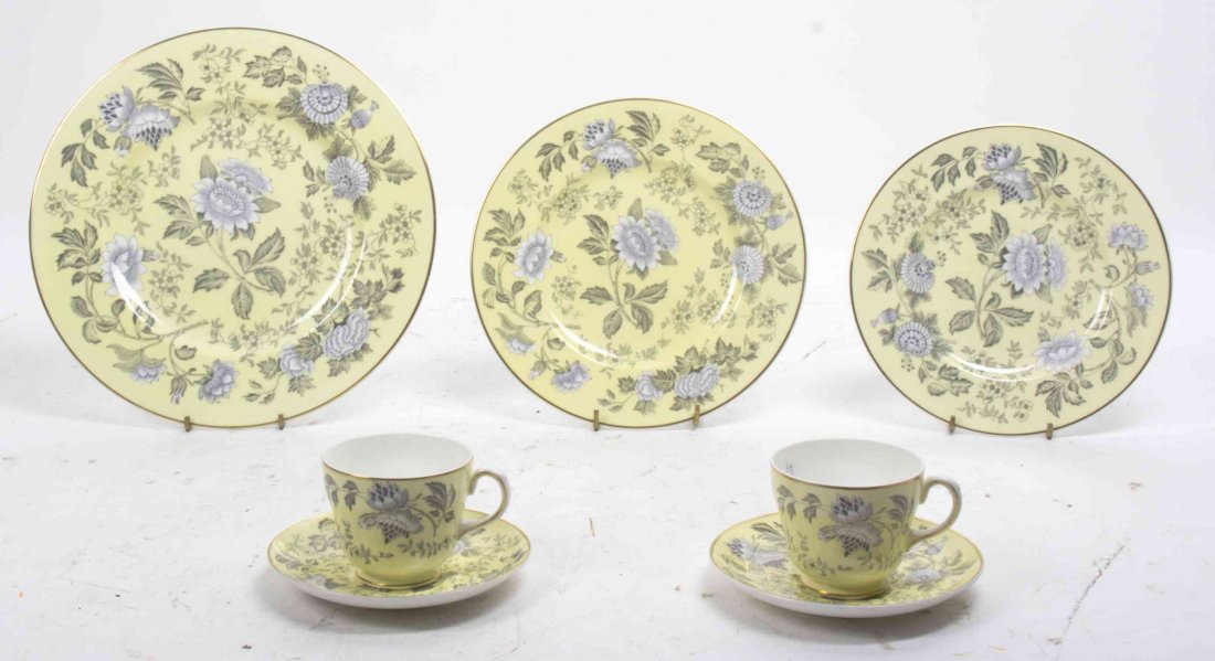 A Wedgwood Porcelain Partial Dinner Service, Diameter: A Wedgwood Porcelain Partial Dinner Service, comprising 12 dinner plates, 13 salad plates, 14 dessert plates, 12 teacups and 12 saucers, each decorated to show floral sprays on a lemon ground; 63 item