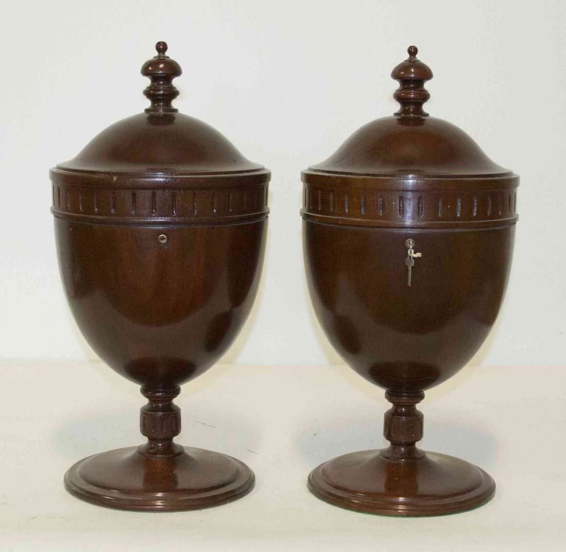 A Pair of Edwardian Knife Boxes, Height 22 1/2 inches.: A Pair of Edwardian Knife Boxes, of urn form, raised on a conforming turned standard and circular base. Height 22 1/2 inches.