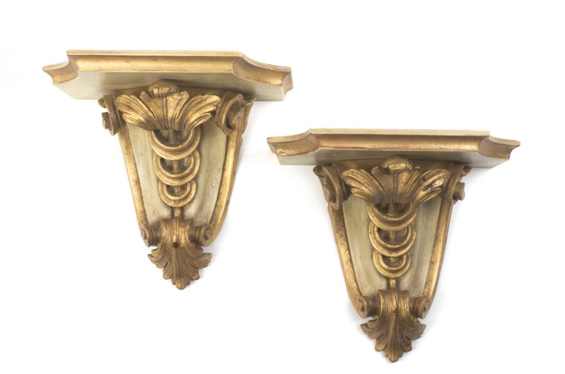 A Pair of Baroque Style Painted and Parcel Gilt Wall: A Pair of Baroque Style Painted and Parcel Gilt Wall Brackets, each with a shaped shelf over a scrolled support. Height 12 1/2 x width 13 x depth 8 1/2 inches. Property of a Lady, St. Augustine, Flori