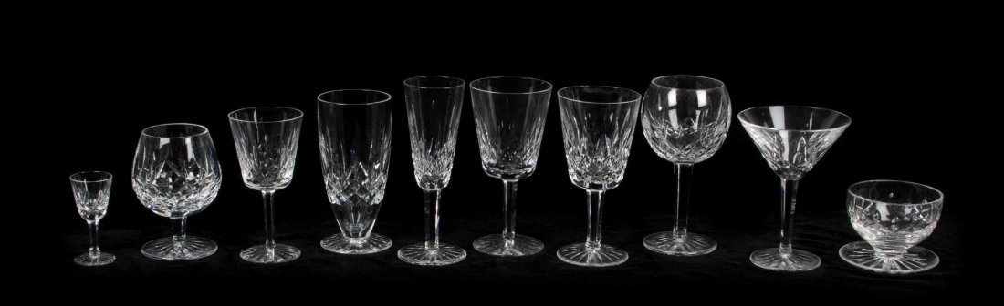 A Collection of Waterford Cut Glass Barware, Height of: A Collection of Waterford Cut Glass Barware, comprising 3 red wines, 6 white wines, 4 waters, 3 martinis, 7 flutes, 11 small wines, 4 scotches, 3 compotes, 2 cordials, 15 stemmed cordials, and 26 tumb