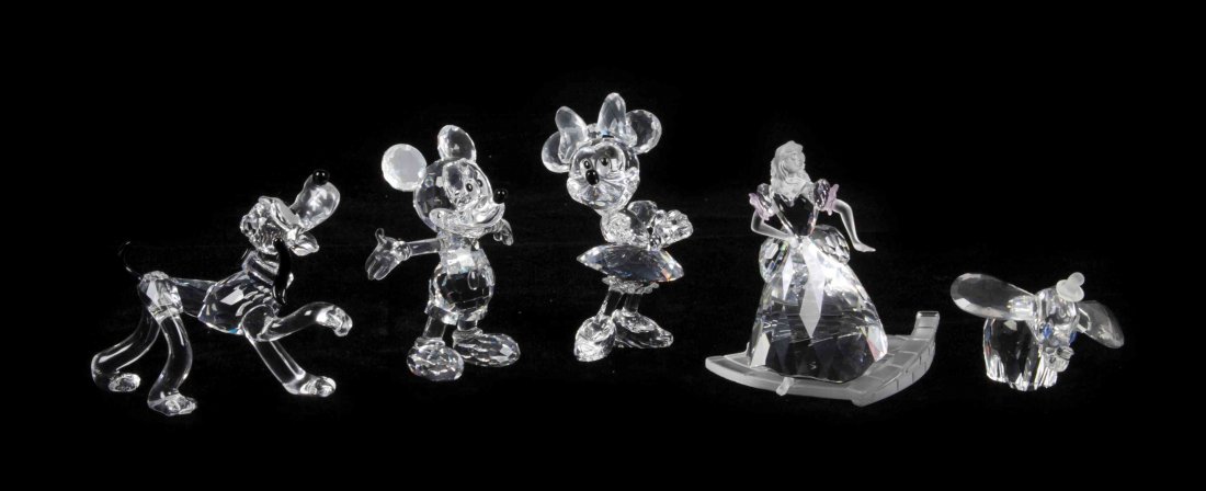 Five Swarovski Cut Glass Figures from the Disney: Five Swarovski Cut Glass Figures from the Disney Collection, comprising Mickey and Minnie Mouse, Pluto, Dumbo, and Cinderella, three with fitted boxes. Height of first 4 inches. Property from the Fran