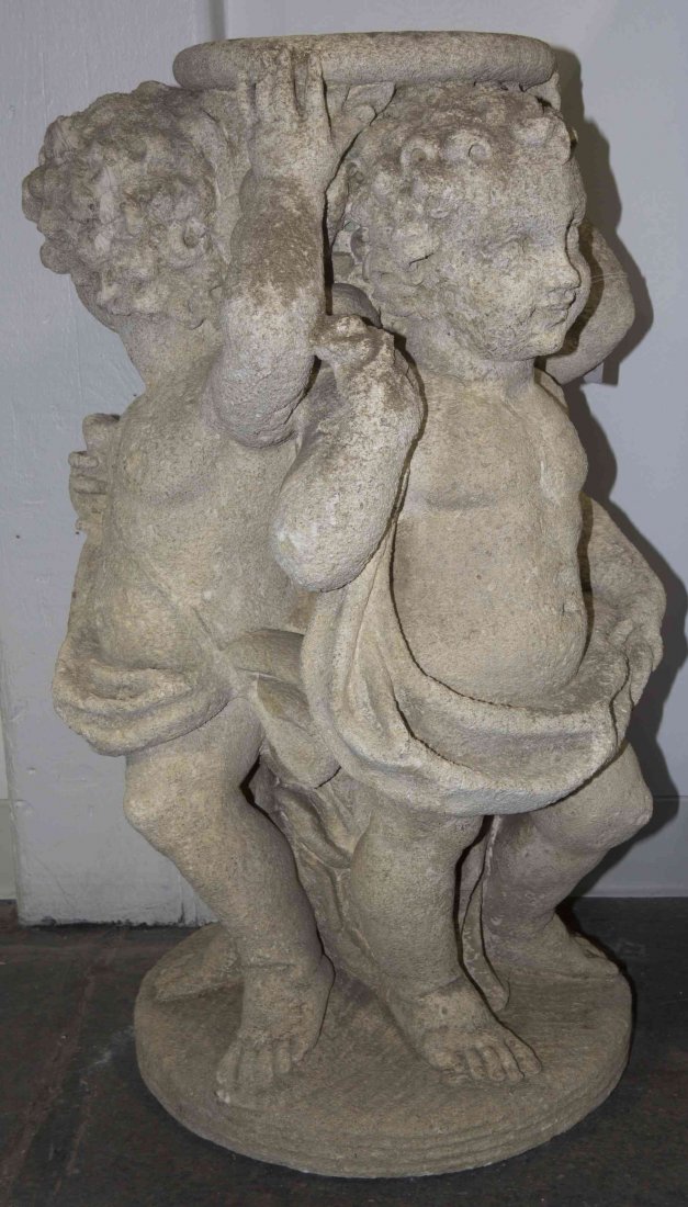 A Cast Stone Table Base, Height of base 32 x diameter: A Cast Stone Table Base, modeled as three putti supporting the associated circular stone top. Height of base 32 x diameter of top 47 1/2 inches. Property of a Lady, St. Augustine, Florida