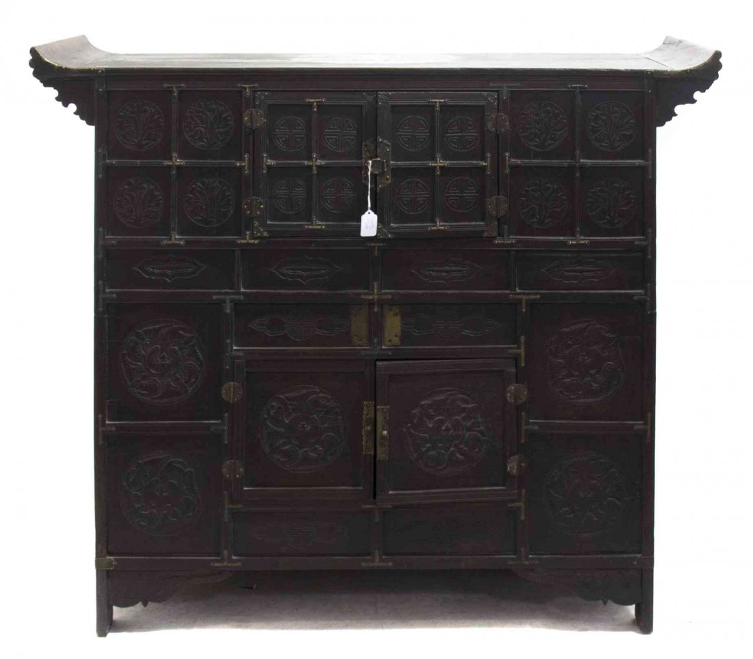 A Chinese Wood Altar Coffer, Height 40 1/2 x width 46 x: A Chinese Wood Altar Coffer, having two pairs of double doors with relief carved shou medallions flanked by floral medallions. Height 40 1/2 x width 46 x depth 18 inches.