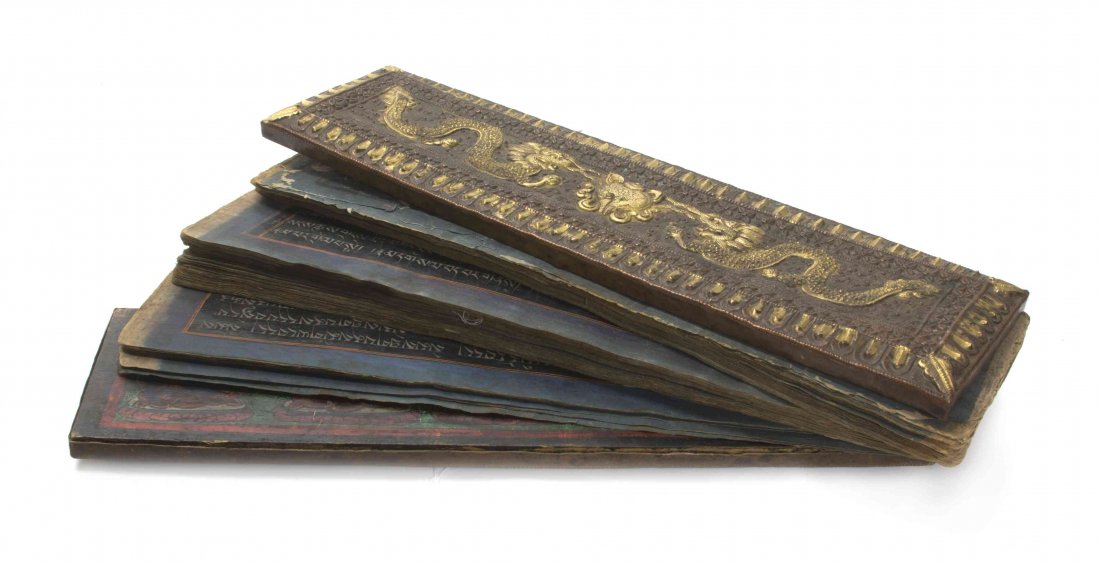 A Tibetan Buddhist Sutra, Width 19 inches.: A Tibetan Buddhist Sutra, with partial gilt metal mounted wood covers. Width 19 inches.