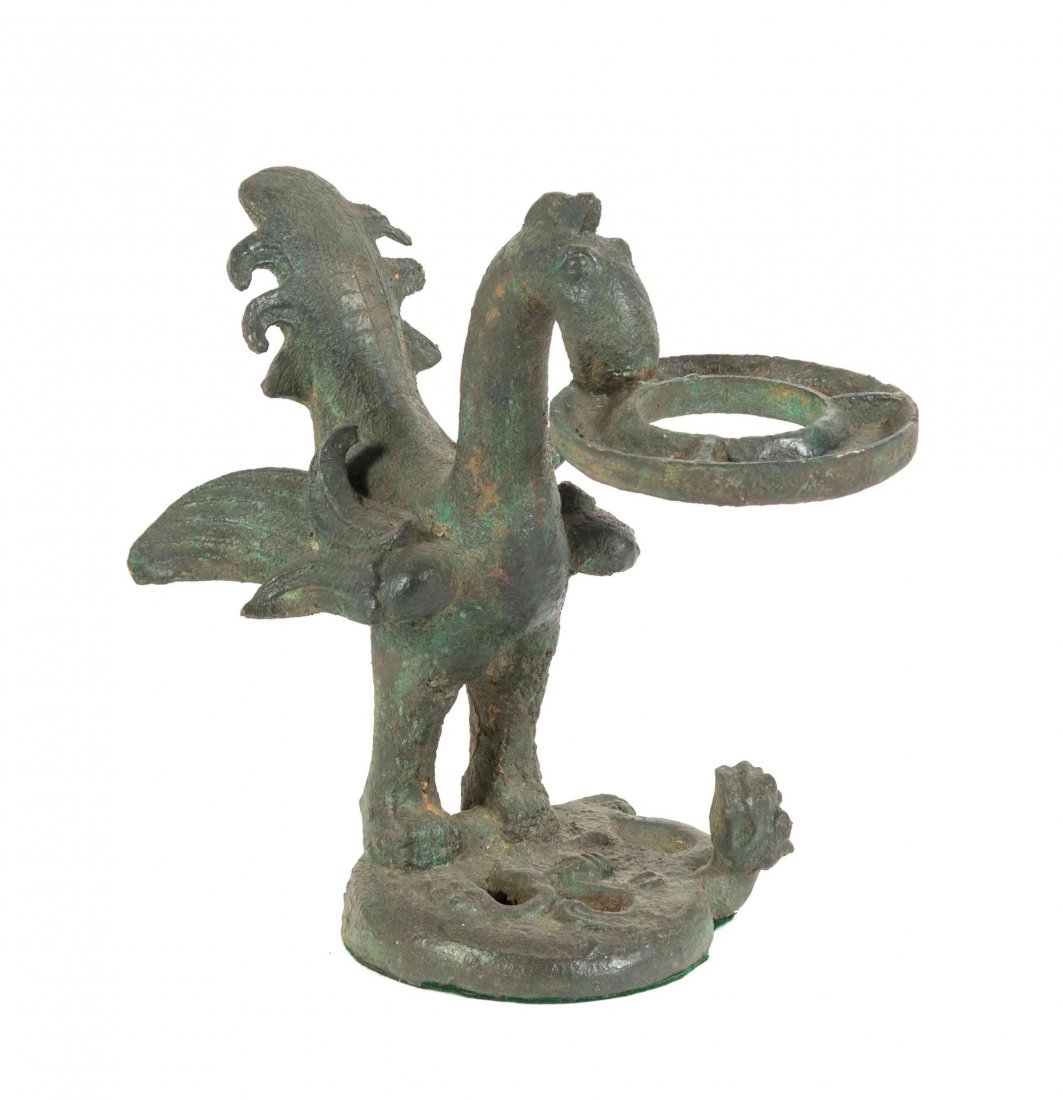A Chinese Bronze Archaistic Bird Form Oil Lamp Stand,: A Chinese Bronze Archaistic Bird Form Oil Lamp Stand, the lamp holder of circular form, supported by the standing bird standard, depicted on a rounded base with a coiled chilong. Height 12 inches. Con