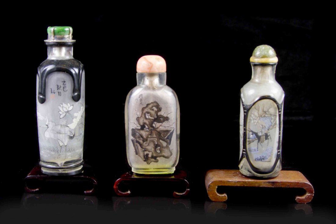 Three Interior Painted Snuff Bottles, Height of tallest: Three Interior Painted Snuff Bottles, the first of compressed flask form and signed Zhou Leyuan Zuo, depicting a pierced scholar's rock, the reverse depicting a traveler riding a donkey through a moun