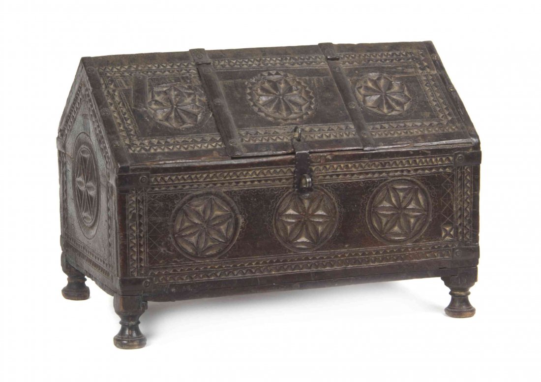An Indian Carved Wood Chest, Width 16 3/4 inches.: An Indian Carved Wood Chest, having relief carved stand and roundel pattern with iron strap hinges raised on four turned feet. Width 16 3/4 inches. Property from the May Weber, M.D., Collection, Chica