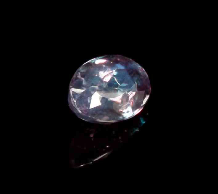 A 0.63 Carat Alexandrite,, , in an oval mixed cut,: A 0.63 Carat Alexandrite, in an oval mixed cut, displaying a moderate color change from reddish purple to gray green. 6.00 x 4.00 mm. Property from the Estate of Gerard L. Cafesjian, Naples, Florida
