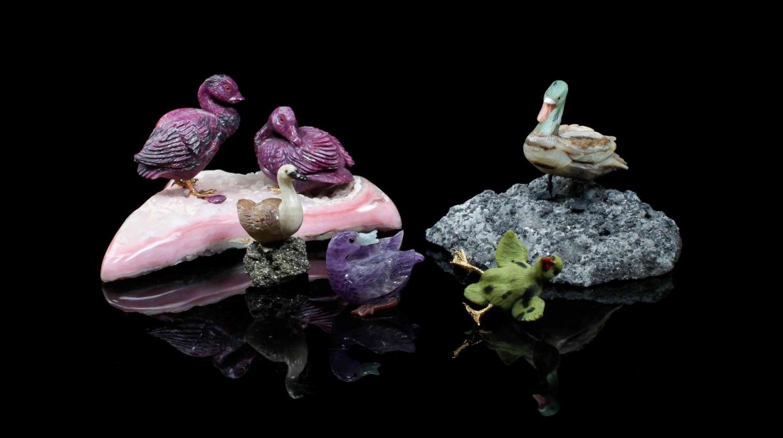 A Collection of Hardstone Duck Carvings,, , consisting: A Collection of Hardstone Duck Carvings, consisting of a pair of ruby ducks on a pink hardstone base, a banded agate and green hardstone duck on a black hardstone and quartz crystal base, an agate duc