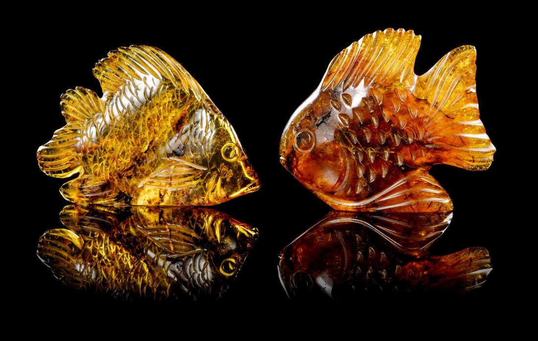 A Collection of Carved Amber Fish,, Oligocene, Santo: A Collection of Carved Amber Fish, Oligocene, Santo Domingo, Dominican Republic, consisting of two whimsical fish carvings of highly translucent yellow amber and deeper golden yellow amber with plant 