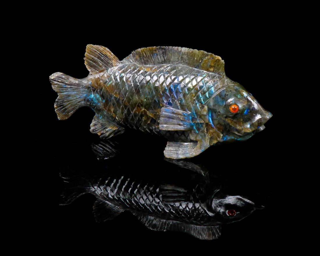 A Carved Labradorite Fish,, , of realistic design, the: A Carved Labradorite Fish, of realistic design, the scaled body displaying the characteristic labradorescence, or color flash, in blues and greens mimicking a shimmering fish in water, inset hand pain
