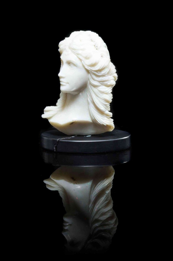 A White Opal and Black Onyx Carving of a Female Bust,: A White Opal and Black Onyx Carving of a Female Bust, Heinz Postler, Idar-Oberstein, Germany, carved from white opal sourced from Coober Pedy, Australia, realistically depicting a graceful female faca