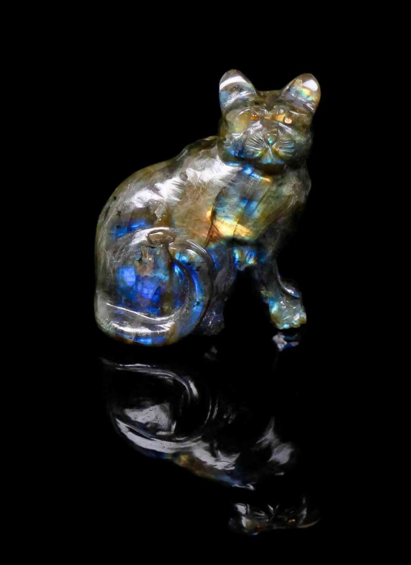 A Labradorite Sculpture of a Cat, 20th Century,, , the: A Labradorite Sculpture of a Cat, 20th Century, the surface displaying the characteristic rich flashes of color, known as labradorescence. 7.11 x 5.97 x 3.81 cm. Property from the Estate of Gerard L. 