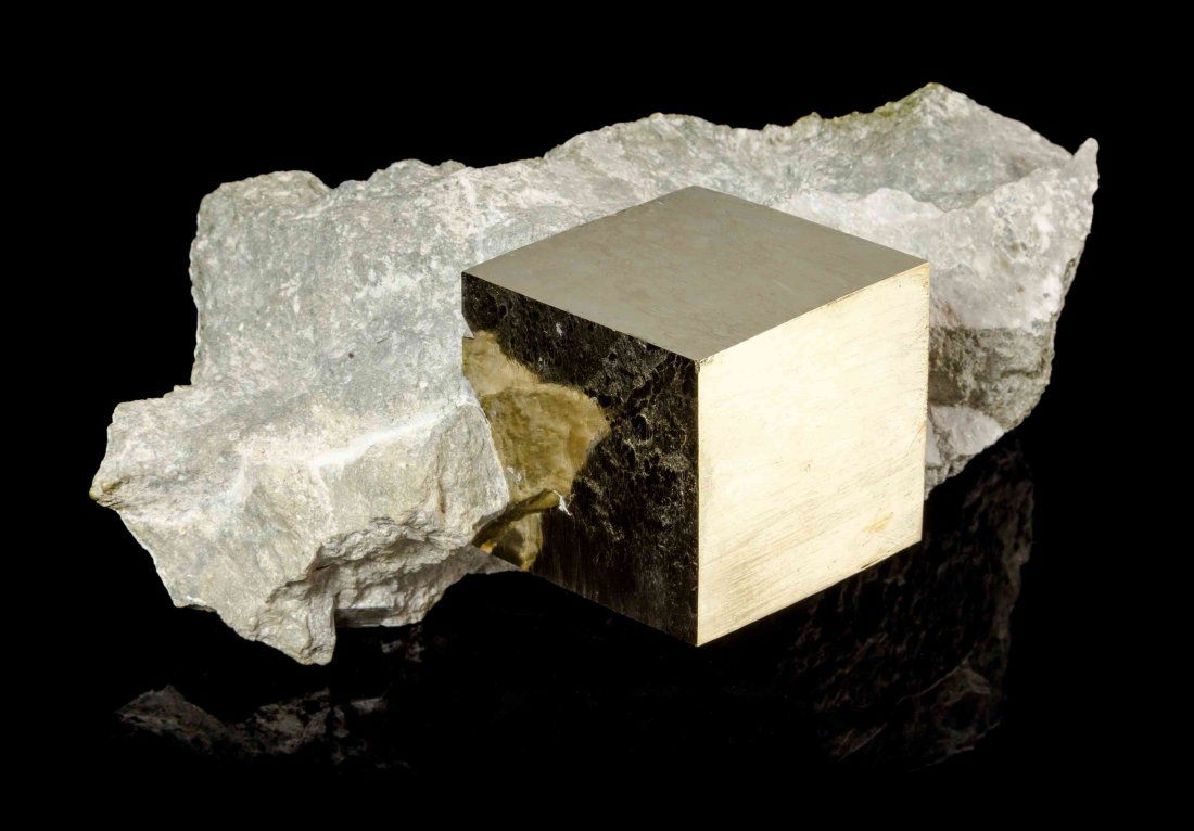 A Pyrite Crystal Specimen,, Navajun, Spain,, consisting: A Pyrite Crystal Specimen, Navajun, Spain, consisting of a single large and euhedral cubic pyrite crystal partially confined within the gray talc matrix. 16.50 x 11.40 x 6.40 cm. Property from the Est