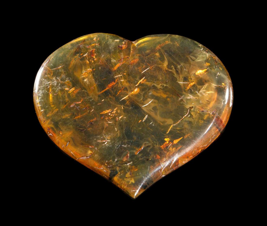 A Blue Amber Heart Carving, Oligocene,, Dominican: A Blue Amber Heart Carving, Oligocene, Dominican Republic, a rare example of this strongly fluorescent variety of amber, hydrocarbons trapped within the amber react to ultraviolet light and glow a not
