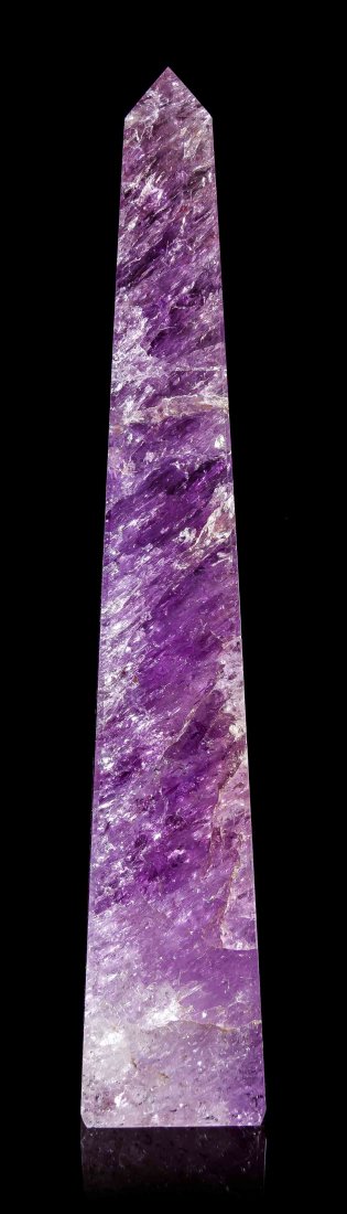 An Amethyst Obelisk,, , of typical graduated form,: An Amethyst Obelisk, of typical graduated form, carved from a large single crystal with evenly distributed internal veils and inclusions which serve to scatter the light, the color ranging from an int