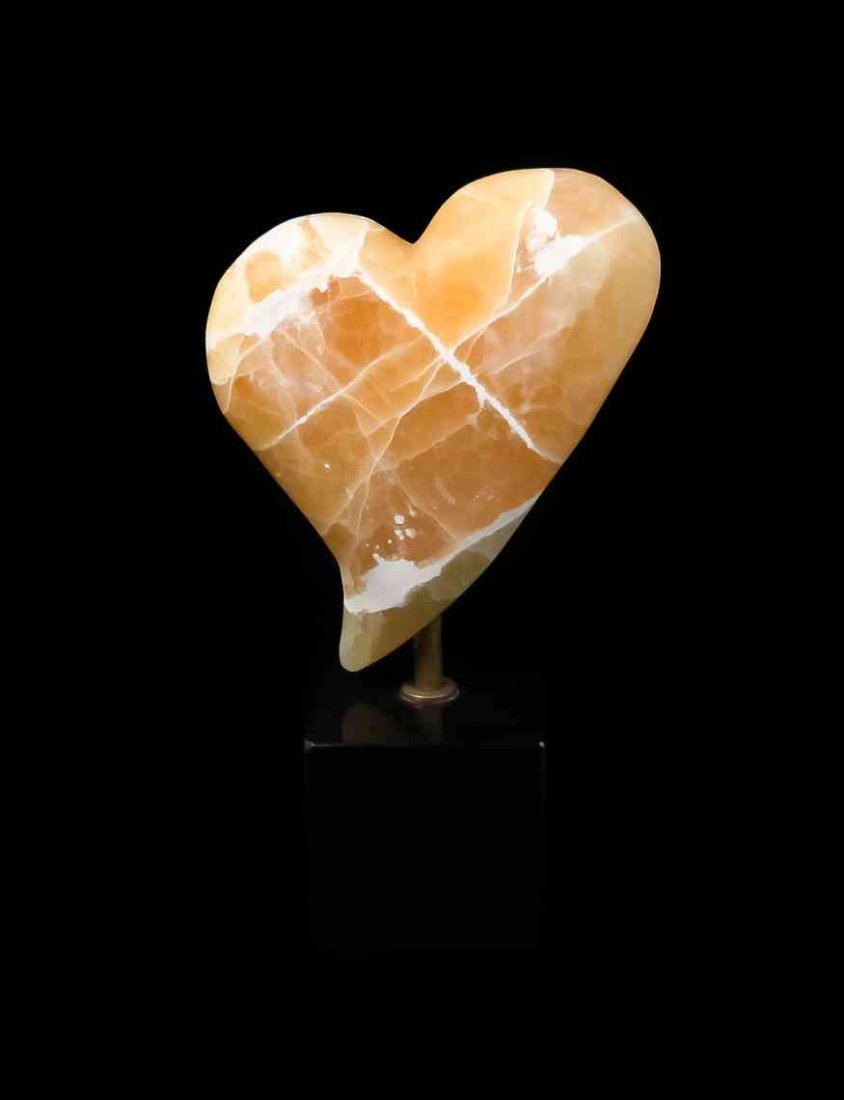 A Honeycomb Calcite Heart Sculpture, David Campbell,,: A Honeycomb Calcite Heart Sculpture, David Campbell, Utah, Unites States, carved in a softly rounded heart shape from Utah sourced and naturally colored golden orange calcite, suspended on a cubic bas
