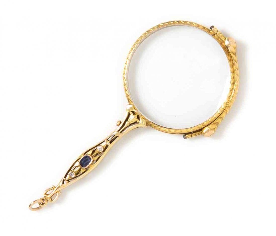 An Art Nouveau Yellow Gold, Sapphire and Diamond: An Art Nouveau Yellow Gold, Sapphire and Diamond Lorgnette, consisting of an openwork handle containing one cushion cut sapphire and two old European cut diamonds weighing approximately 0.02 carat tot