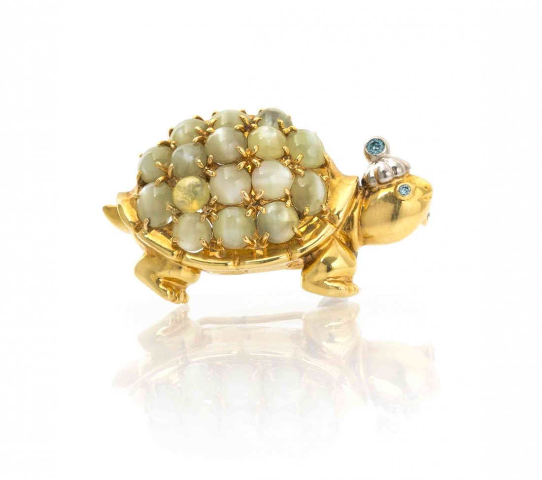 An 18 Karat Yellow Gold, Platinum, Cat's Eye: An 18 Karat Yellow Gold, Platinum, Cat's Eye Chrysoberyl and Irradiated Color Diamond Turtle Brooch, containing 16 round and oval cabochon cut cat's eye chrysoberyl weighing approximately 14.11 carats