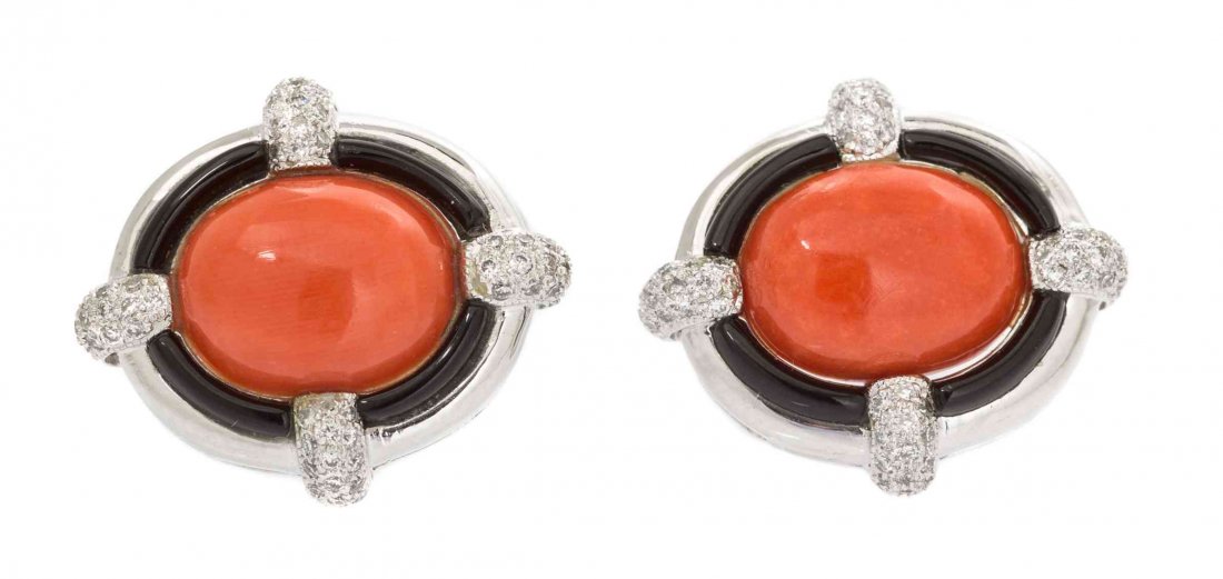 A Pair of 18 Karat White Gold, Coral, Onyx and Diamond: A Pair of 18 Karat White Gold, Coral, Onyx and Diamond Cufflinks, Eli Frei, containing two oval cabochon cut orange pink coral measuring approximately 11.50 x 9.10 mm, eight curved sections of onyx an