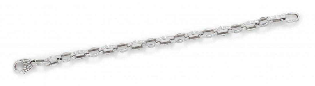 An 18 Karat White Gold Link Bracelet, Roberto Coin,: An 18 Karat White Gold Link Bracelet, Roberto Coin, consisting of textured navette shape links, the clasp containing numerous round brilliant cut diamonds weighing approximately 0.20 carat total and o