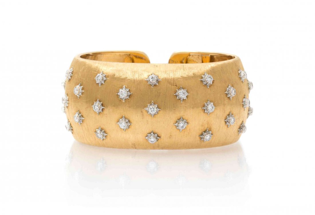A Vintage 18 Karat Gold and Diamond Cuff Bracelet,: A Vintage 18 Karat Gold and Diamond Cuff Bracelet, Gianmaria Buccellati, consisting of an intricately textured yellow gold base with applied white gold rosettes containing 27 collet set round brillian