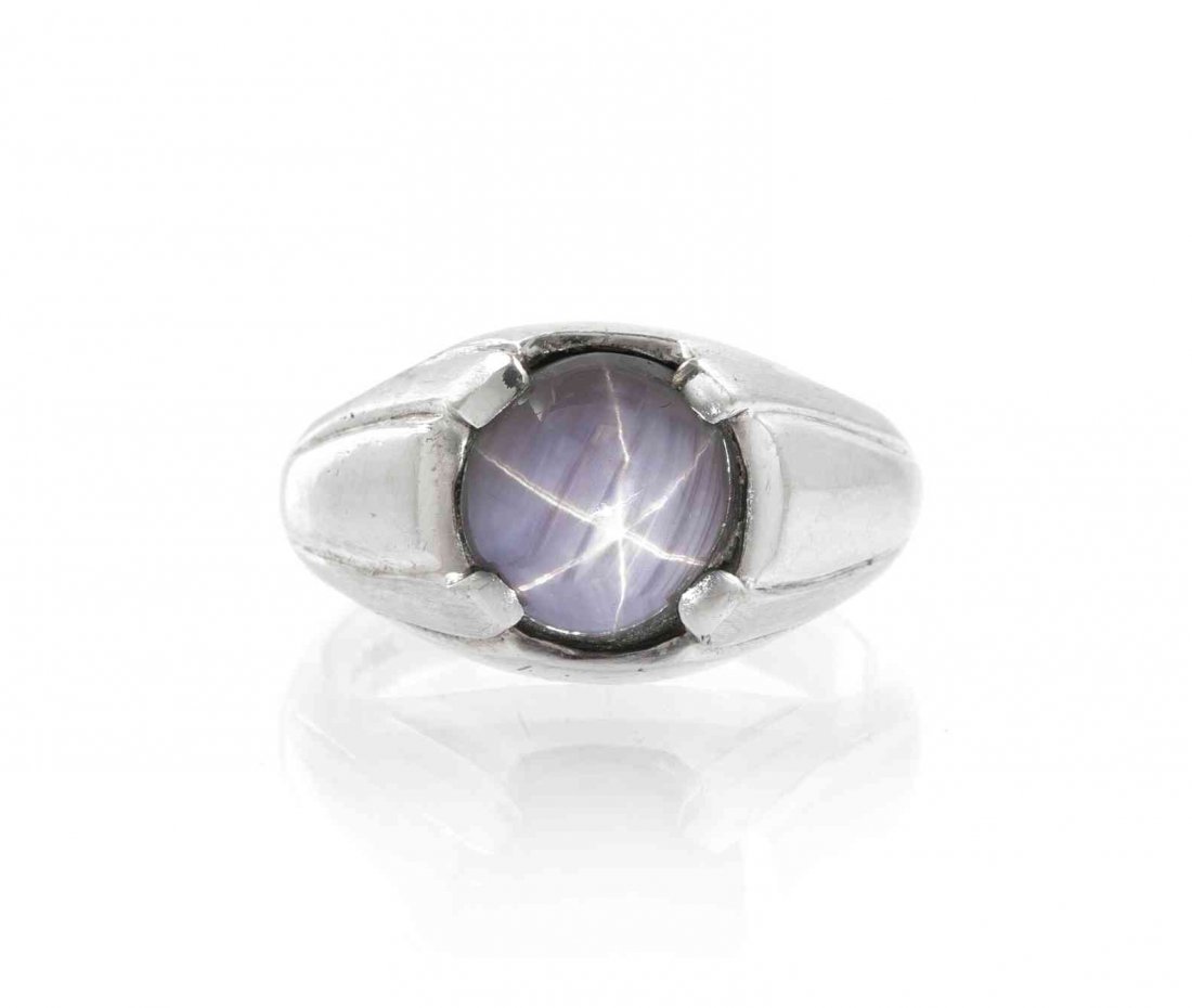 A 14 Karat White Gold and Star Sapphire Ring, 5.40: A 14 Karat White Gold and Star Sapphire Ring, containing one round cabochon cut star sapphire measuring approximately 10.09-9.65 mm. Stamp: P14K. 5.40 dwts. Property from the Estate of Dr. John P. & S