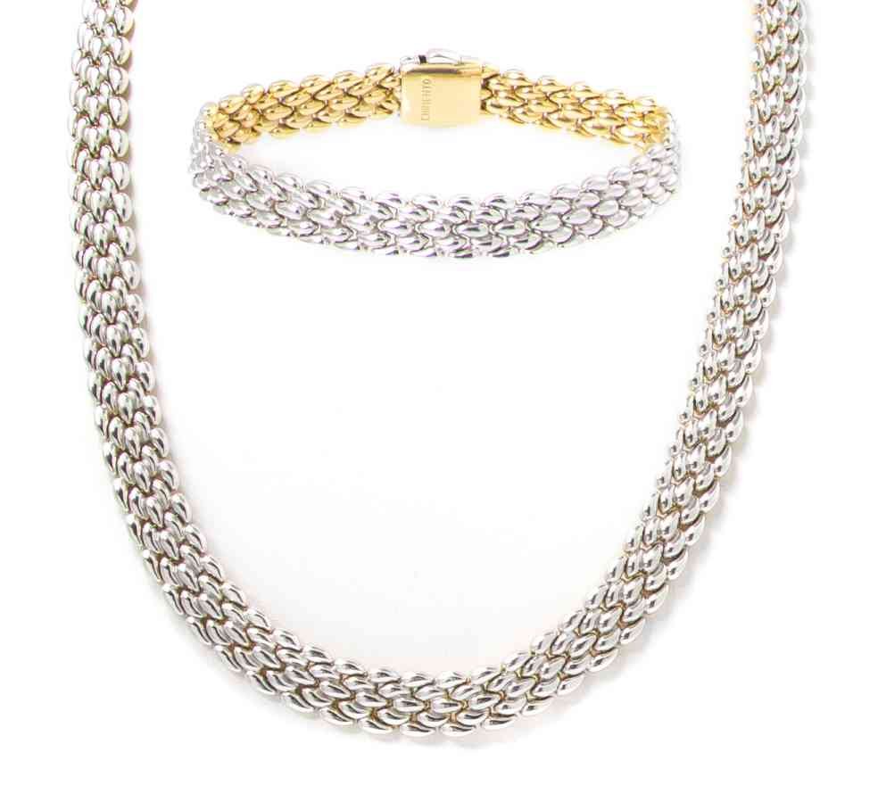 An 18 Karat Yellow and White Gold Reversible Demi: An 18 Karat Yellow and White Gold Reversible Demi Parure, Chimento, consisting of a reversible matching panther link necklace and bracelet. Stamp: CHIMENTO 750 MOD DEP (maker's mark). 42.00 dwts. Prop
