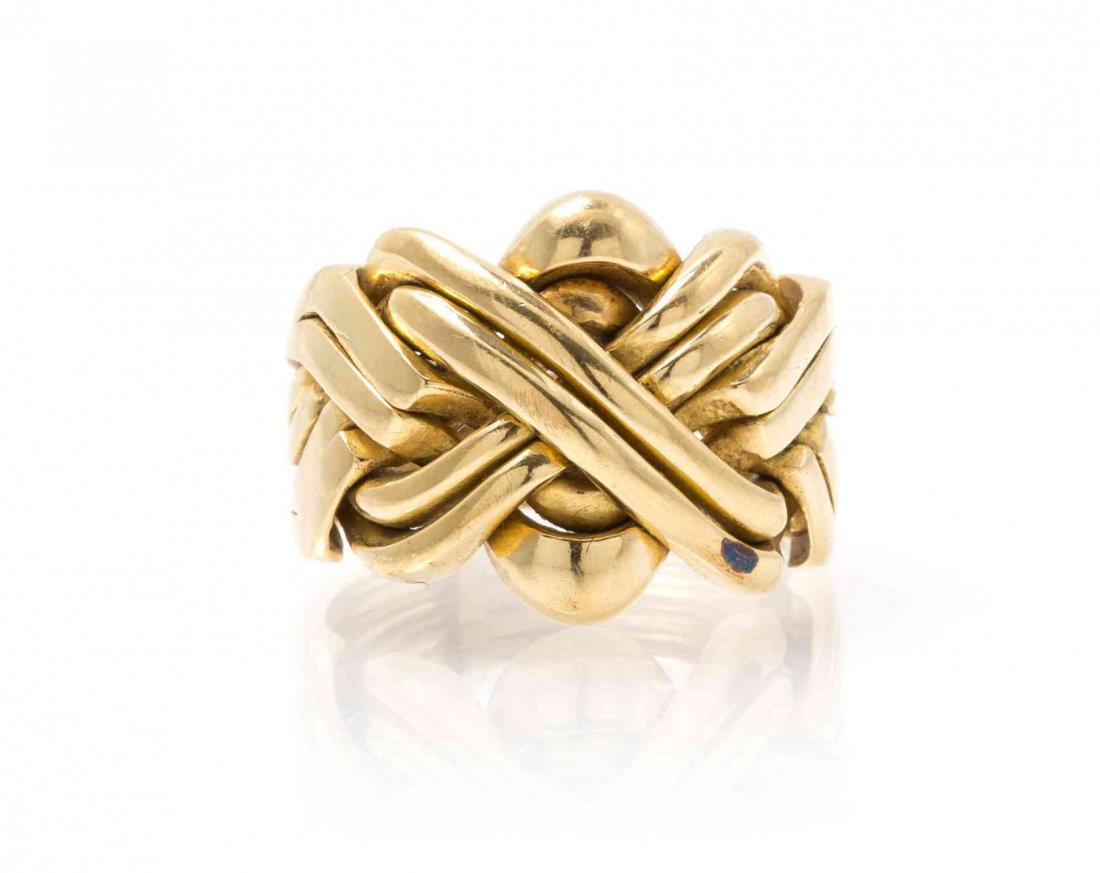 A 14 Karat Yellow Gold Puzzle Ring, 6.50 dwts.: A 14 Karat Yellow Gold Puzzle Ring, containing eight interlocking ring in a criss-cross design. Stamp: 585. 6.50 dwts. Property from the Estate of Dorothy Parrott Hughes, Kenilworth, Illinois Conditio