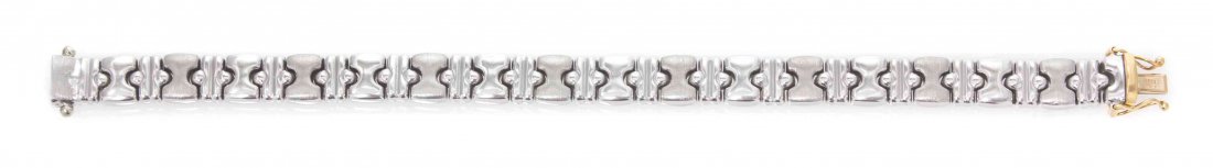An 18 Karat Yellow and White Gold Reversible Bracelet,: An 18 Karat Yellow and White Gold Reversible Bracelet, fancy link chain with polished and textured finish. Stamp: 18K ITALY. 14.90 dwts. Property from the Estate of Marlys A. Berg, Dubai, United Arab 