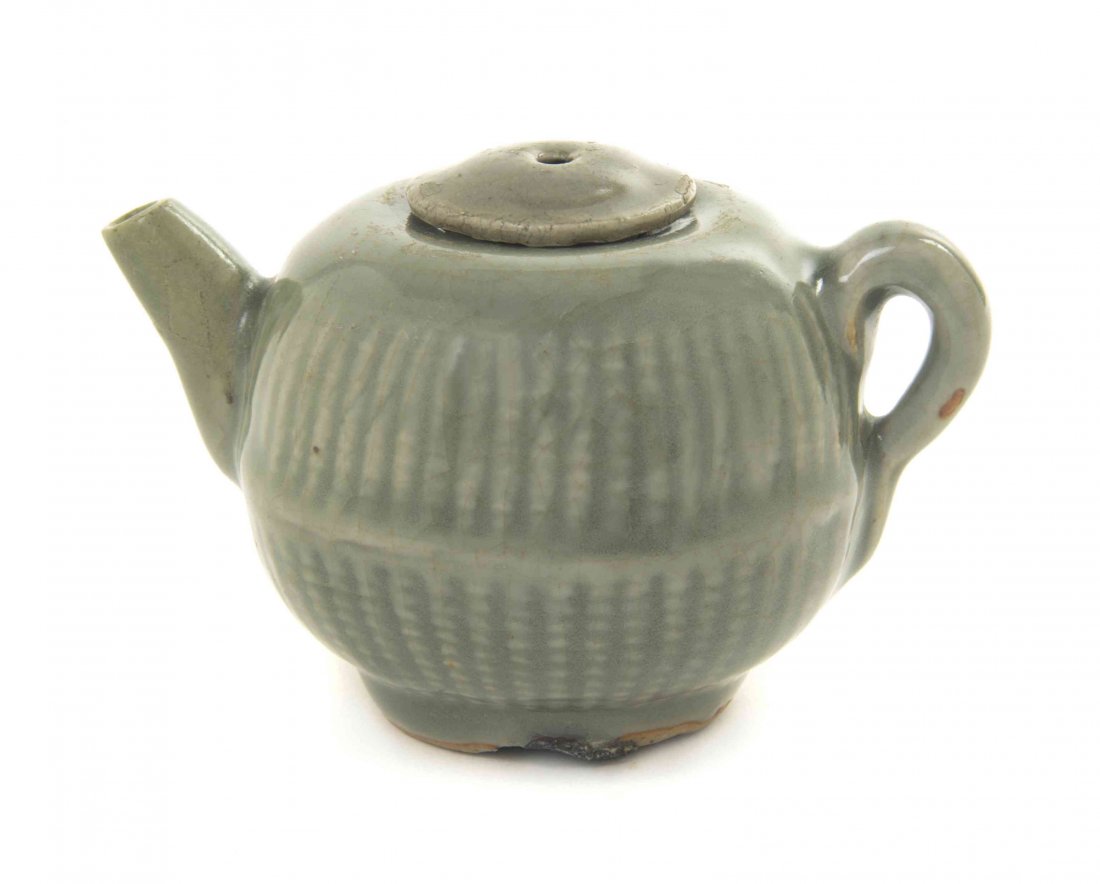 A Longquan Celadon Glaze Teapot and Cover, Width 4 3/8: A Longquan Celadon Glaze Teapot and Cover, SONG (960-1279) OR MING DYNASTY (1368-1644) covered in a thick glaze, having two registers of vertical grooves separated by a raised horizontal rib, with an 