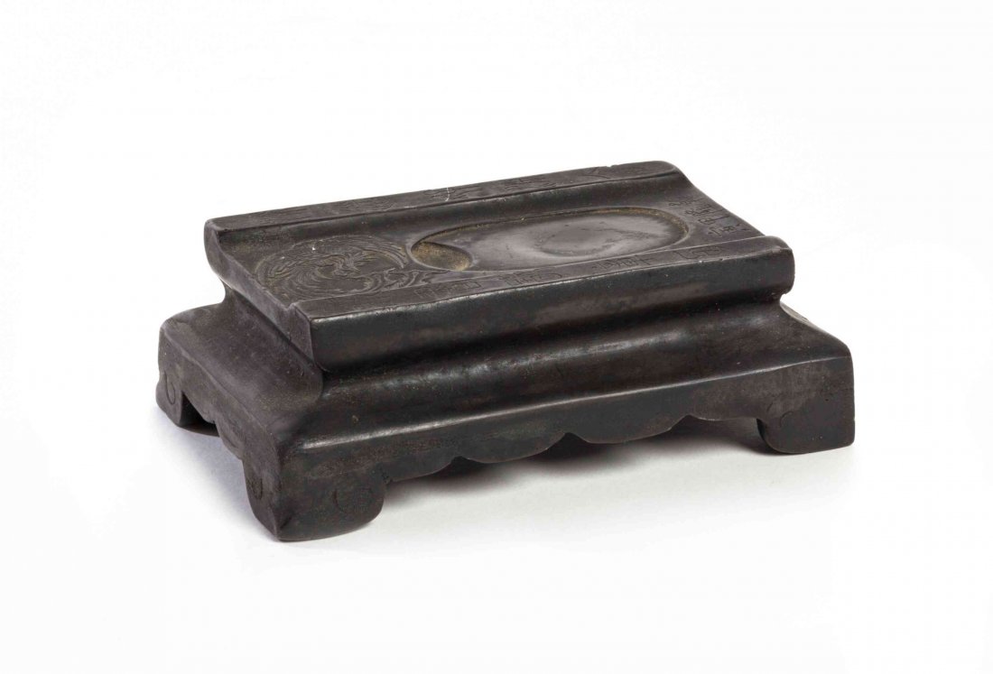 A Black Inkstone Stand, Width 4 3/4 inches.: A Black Inkstone Stand, having a carved phoenix roundel and inscription, raised on a bracket base with scalloped apron. Width 4 3/4 inches.