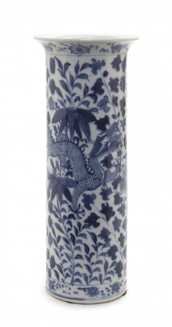 A Chinese Porcelain Beaker Vase, Height 12 3/4 inches.: A Chinese Porcelain Beaker Vase, having blue and white decoration depicting dragons among trees and leafy vines with four-character Kangxi reign mark to the underside. Height 12 3/4 inches. Property f