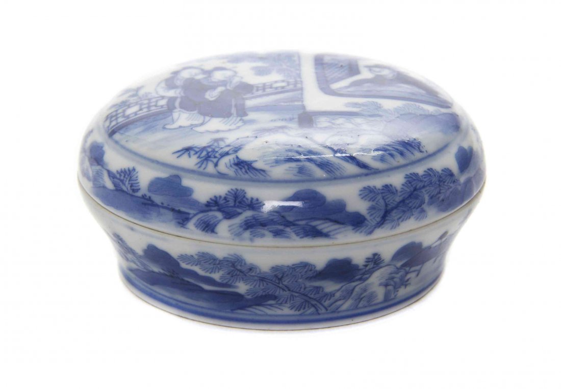A Blue and White Porcelain Seal Paste Box, Diameter 3: A Blue and White Porcelain Seal Paste Box, 18th/19th Century depicting a scholar seated in an interior setting and gazing through a window at two ladies in a garden, with landscape borders, bearing ba