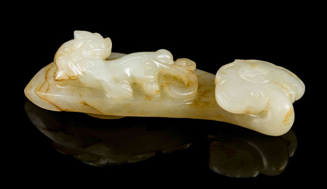 A White Jade Ruyi, Width 3 1/2 inches.: A White Jade Ruyi, with russet veining, having a chilong recumbent on top. Width 3 1/2 inches. Property from the Collection of James S. Frankenberger, Downers Grove, Illinois