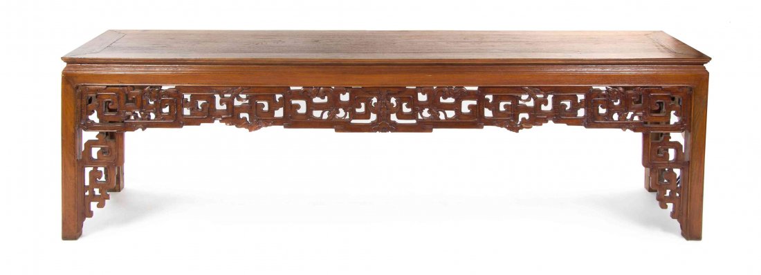 A Chinese Carved Hardwood Altar Table, Height 29 x: A Chinese Carved Hardwood Altar Table, having a rectangular top over a stepped waste and pierced carved sinuous dragon and leiwen apron, raised on block legs, likely cut. Height 29 x width 101 x depth