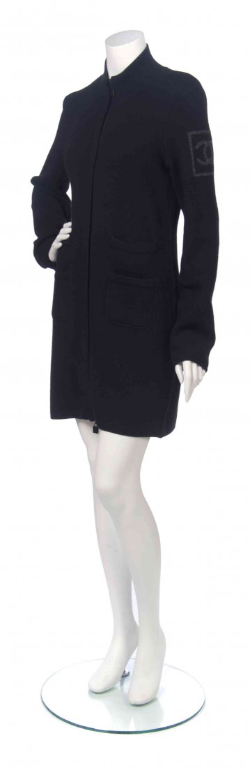 A Chanel Black Wool Knit Cardigan, Size 40.: A Chanel Black Wool Knit Cardigan, long zippered sleeves, a grey interlocking 'C' logo to the left sleeve, two slip and two patch pockets, with a ribbed trim. Labeled: Chanel. Size 40. Condition: Over