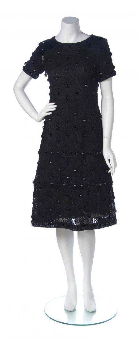 An Yves Saint Laurent for Christian Dior Black Cocktail: An Yves Saint Laurent for Christian Dior Black Cocktail Dress, circa 1958, sheer embroidered overdress with short sleeves, a jewel neckline and domed jet beading, with an attached black and nude slip